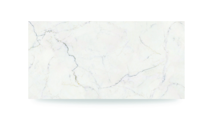 The image shows a white surface with subtle gray and beige veining, creating a soft, irregular pattern, resembling a polished marble countertop.