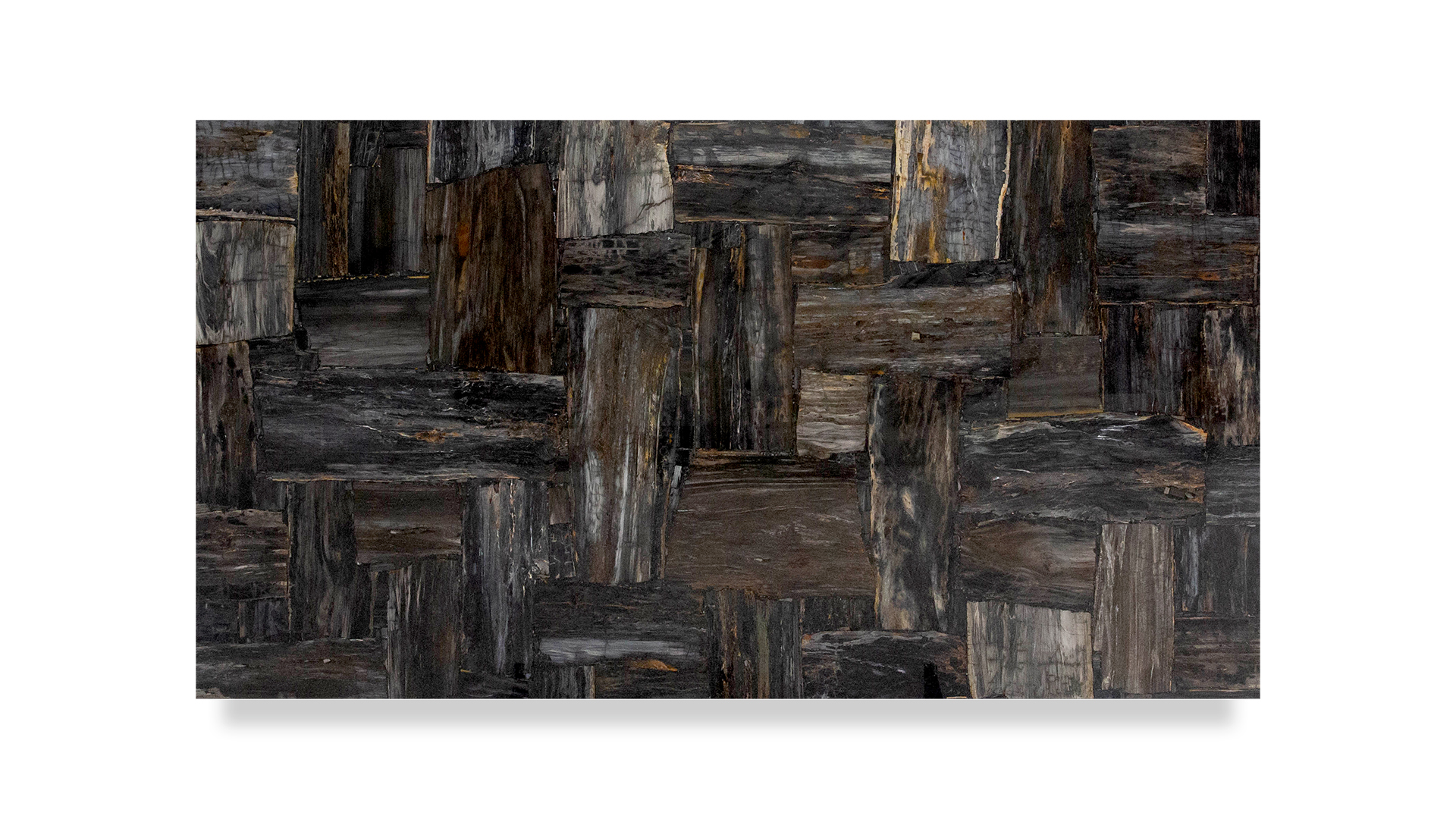 A slab of semi-precious petrified wood, featuring a mosaic of dark, earthy tones. The surface shows various shades of brown, black, and grey, with a textured, natural wood grain appearance.