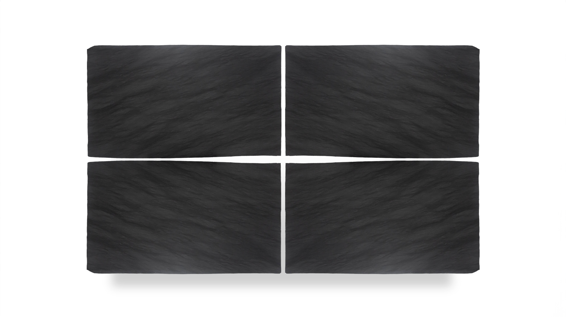 A quad arrangement of Black Vermont Brushed slabs, showcasing a smooth, matte black surface with subtle natural texture and grain patterns.