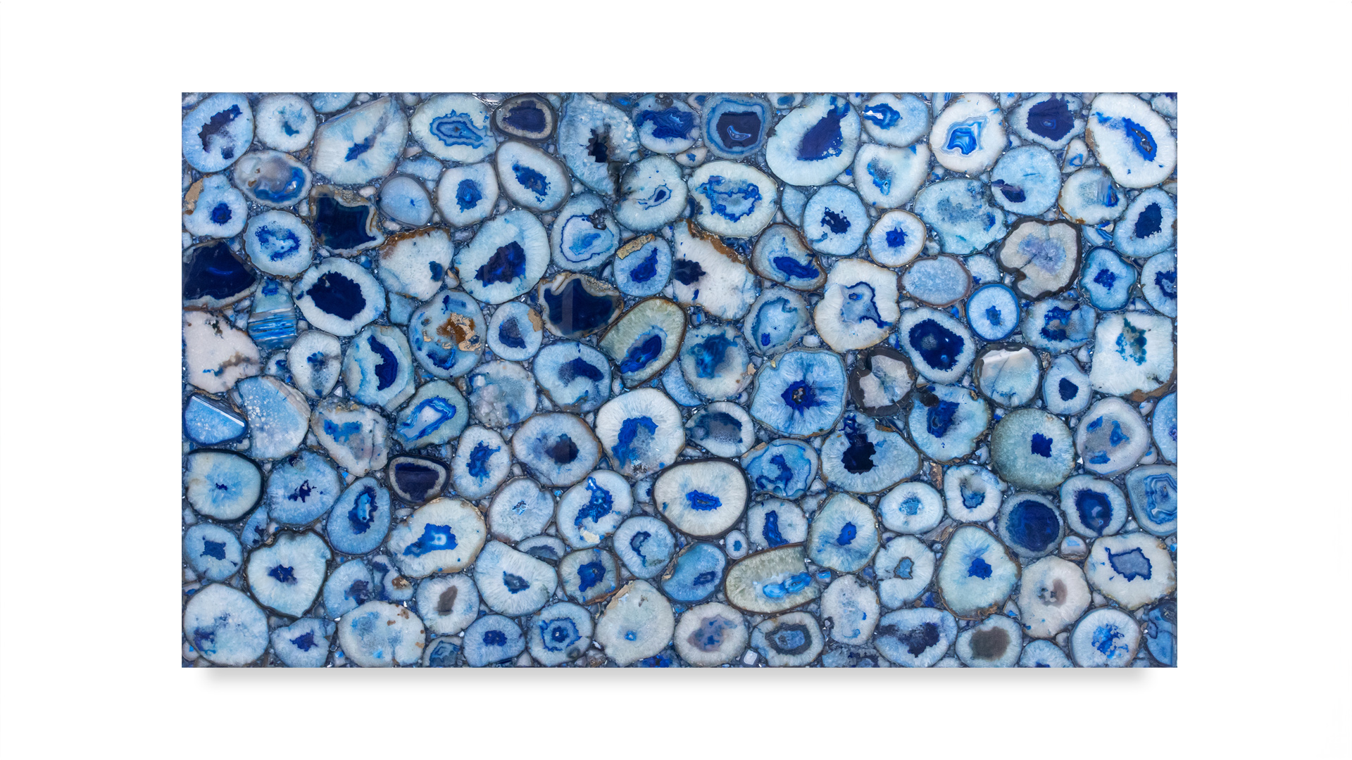 A single blue agate slab featuring numerous vibrant blue circular patterns with white and grey accents, showcasing its natural beauty.