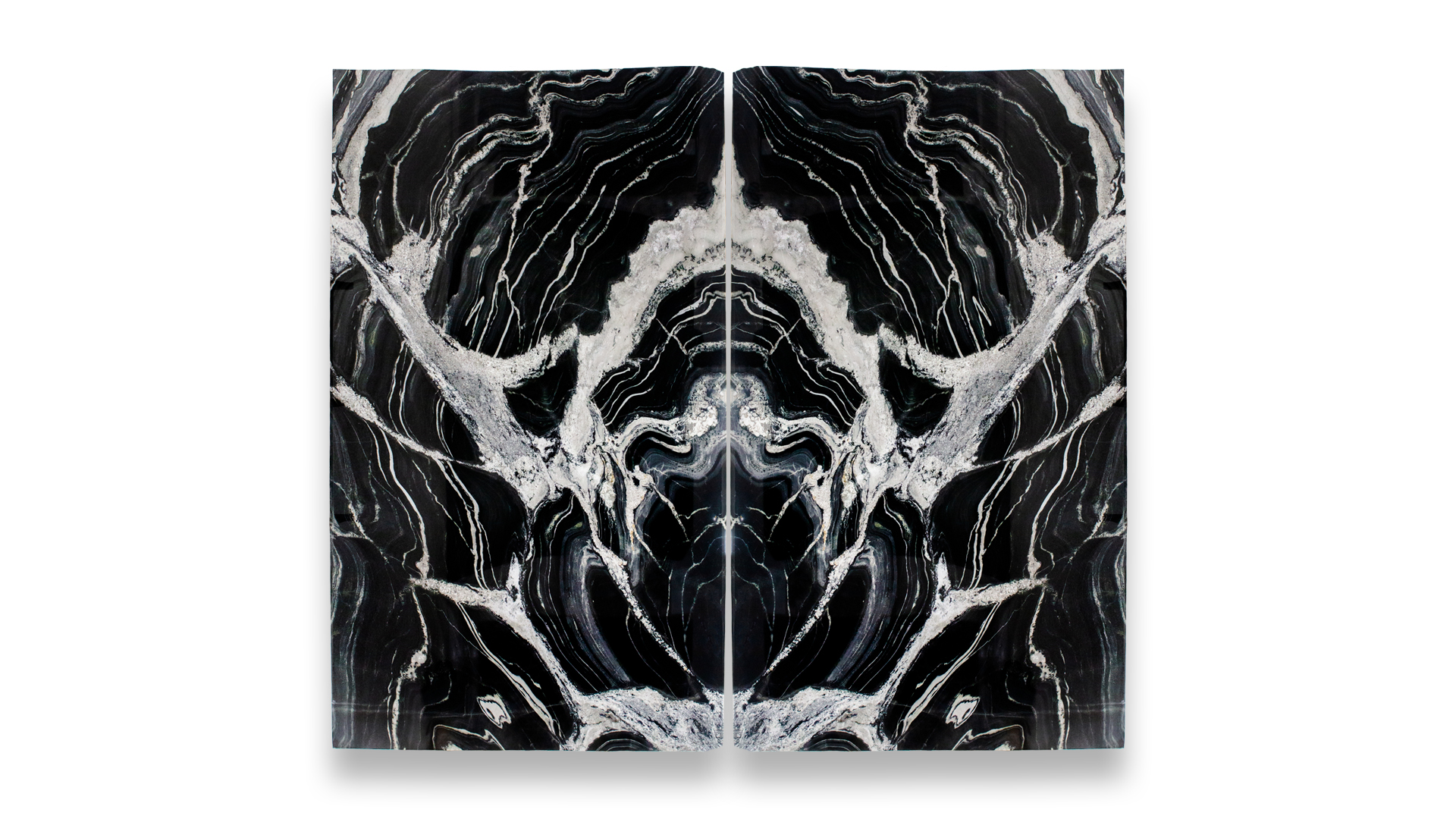 A duo set of polished Eclipse marble slabs with bold black and white patterns, featuring intricate swirls and lines, creating a mirrored, symmetrical effect.