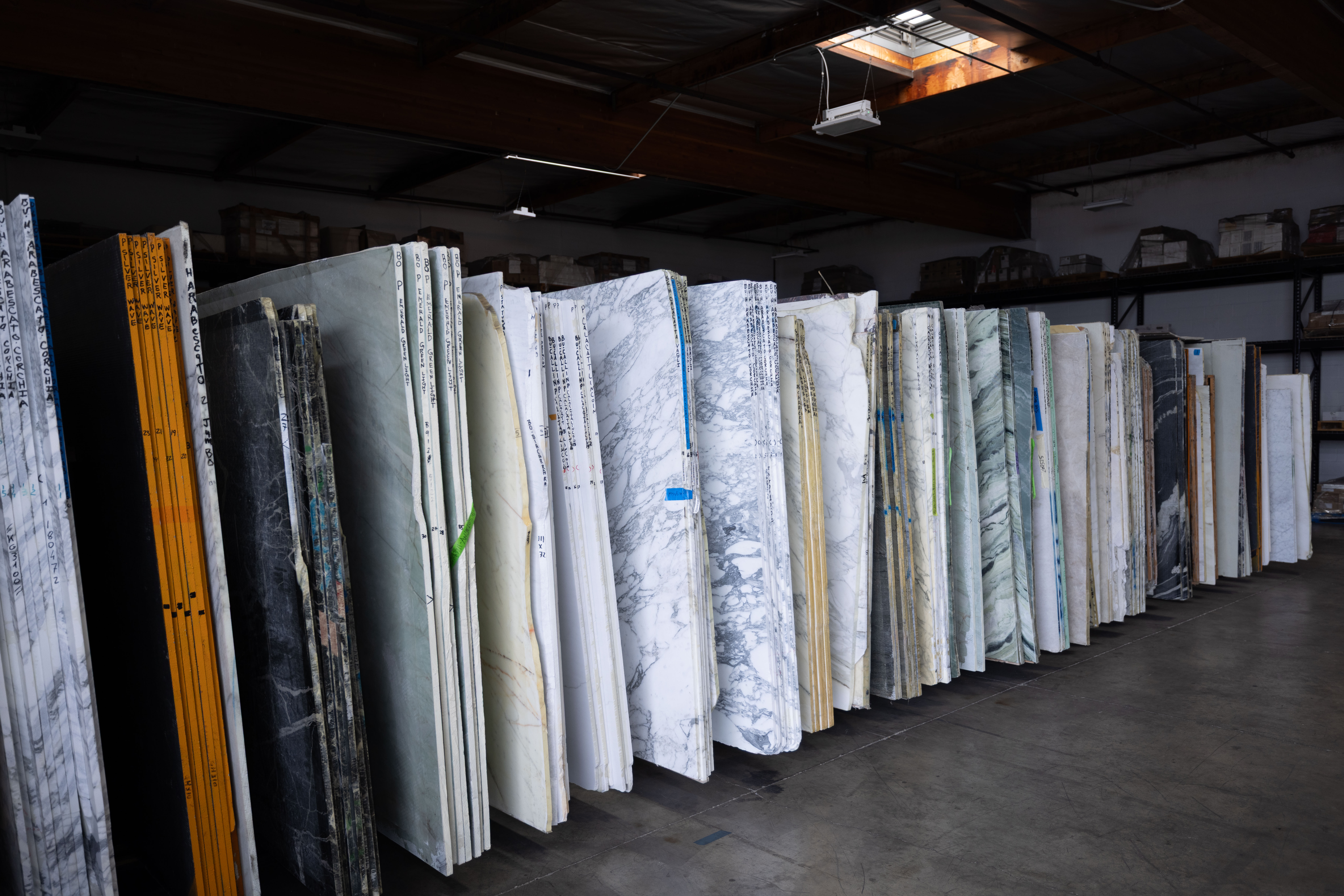Rows of natural stone and quartzite slabs available at The Slab Studio showroom and warehouse in Southern California.