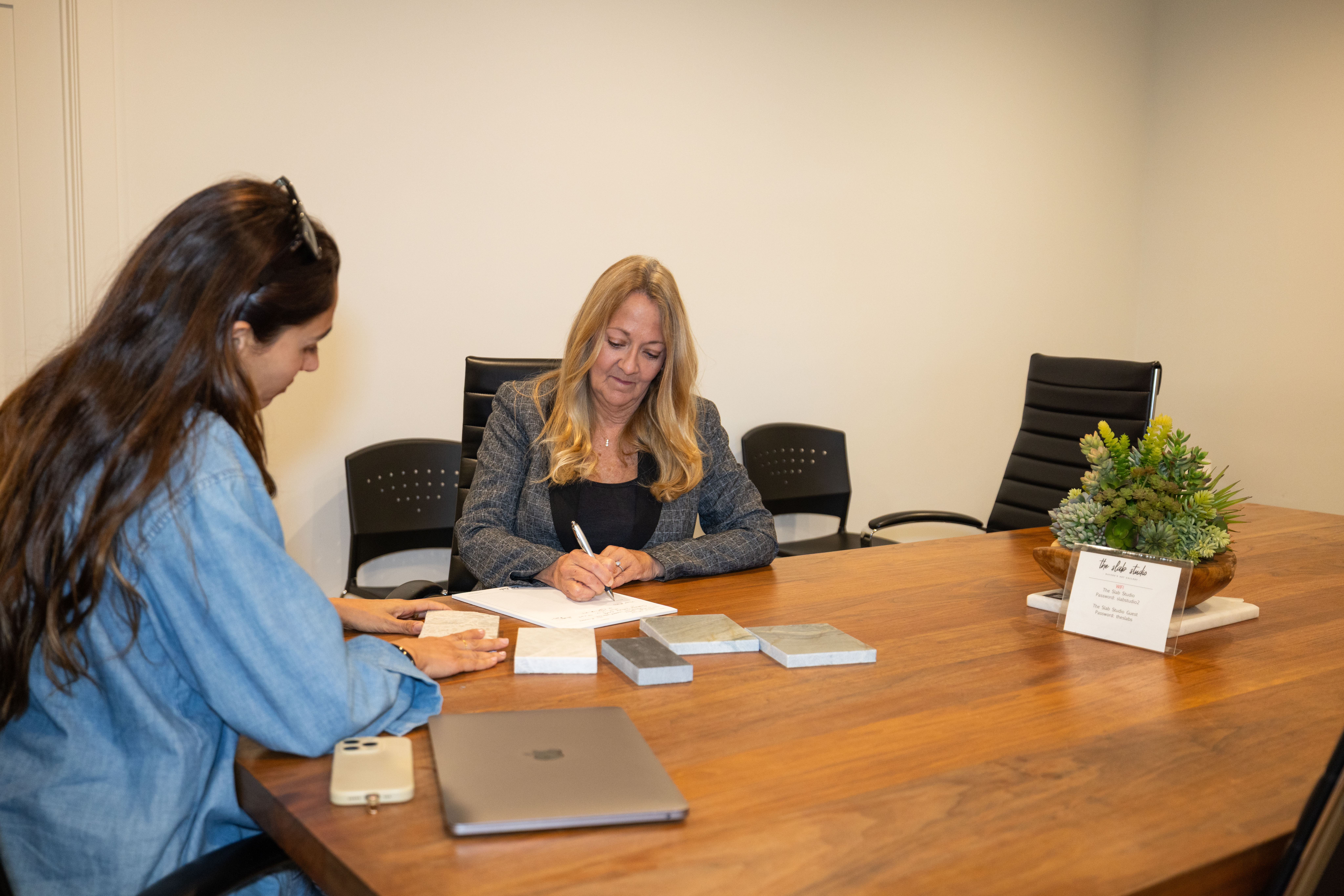 Book-Match Design Consultation | The Slab Studio Designer meeting with The Slab Studio team to review natural stone selections for a book-matched project in Santa Ana.