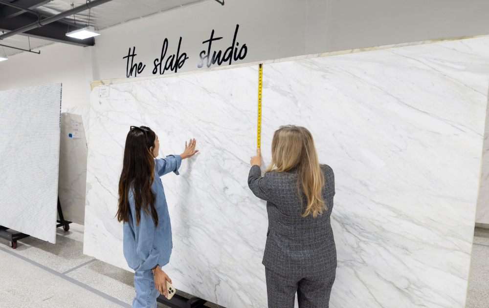 Trade professionals reviewing premium natural stone slabs with The Slab Studio team during a sourcing consultation in Santa Ana, California.