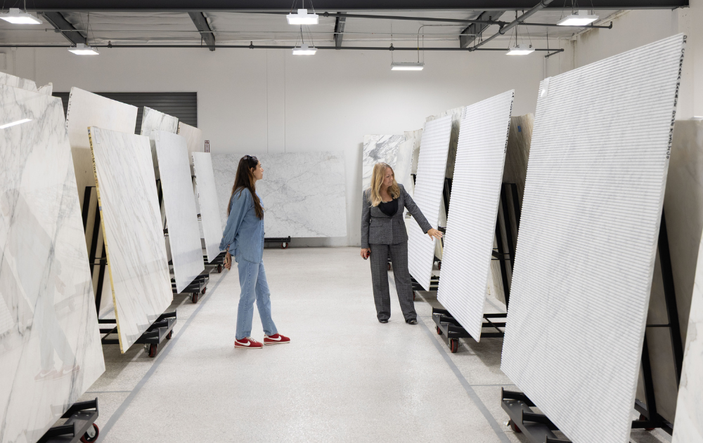 Trade Professionals Reviewing Natural Stone Slabs at The Slab Studio Interior designer and The Slab Studio team member reviewing full natural stone slabs in the Santa Ana warehouse before making a material selection.