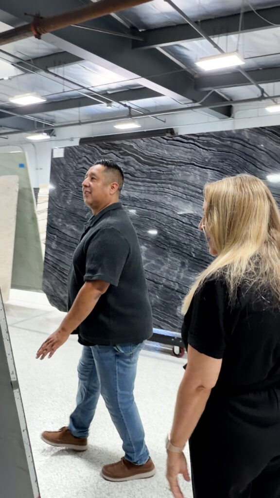 Natural Stone Sourcing Consultation at The Slab Studio Jill Kummer and a trade client reviewing premium natural stone slabs during a sourcing consultation at The Slab Studio showroom in Santa Ana, California.