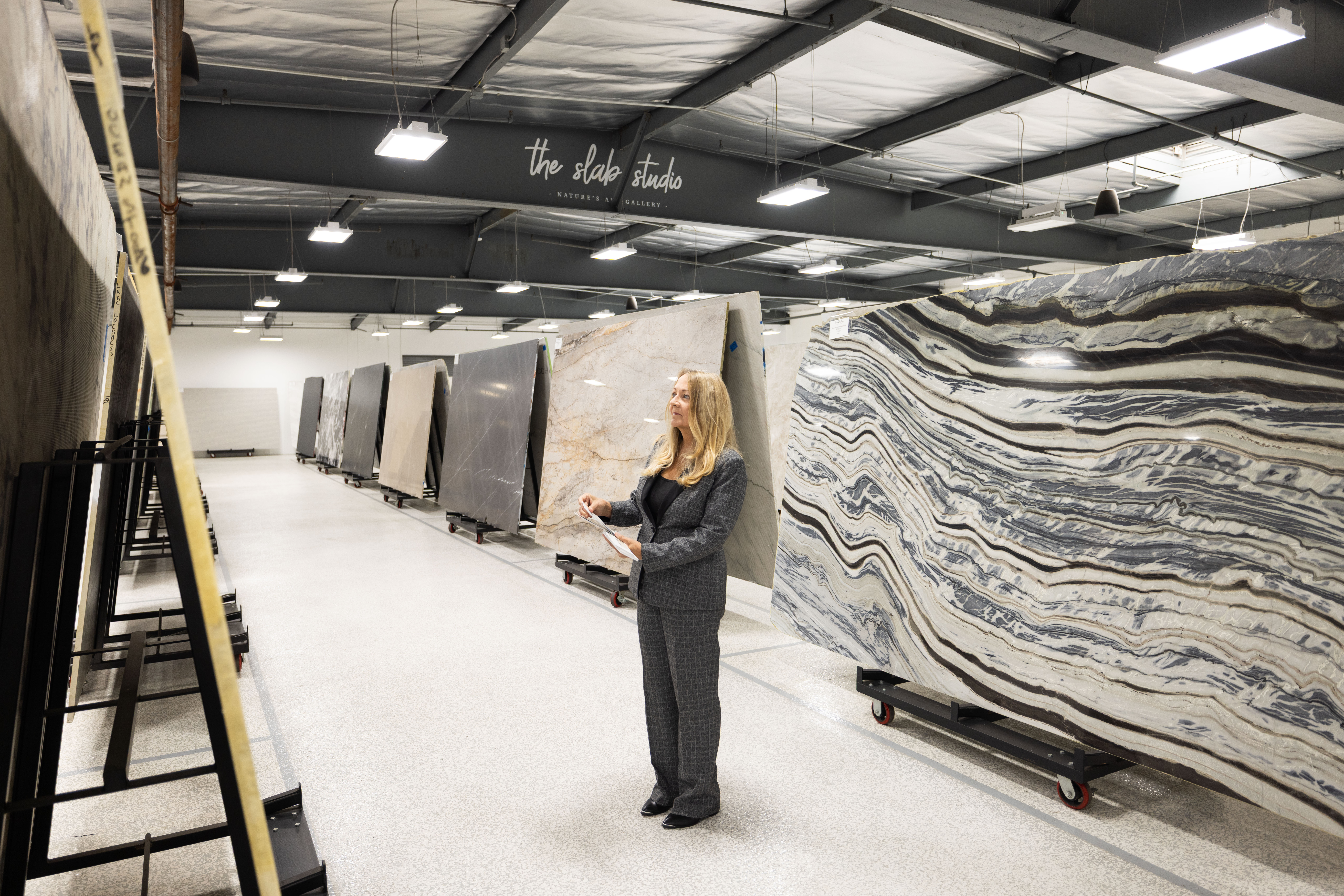 Jill Kummer evaluating slab inventory at The Slab Studio Santa Ana