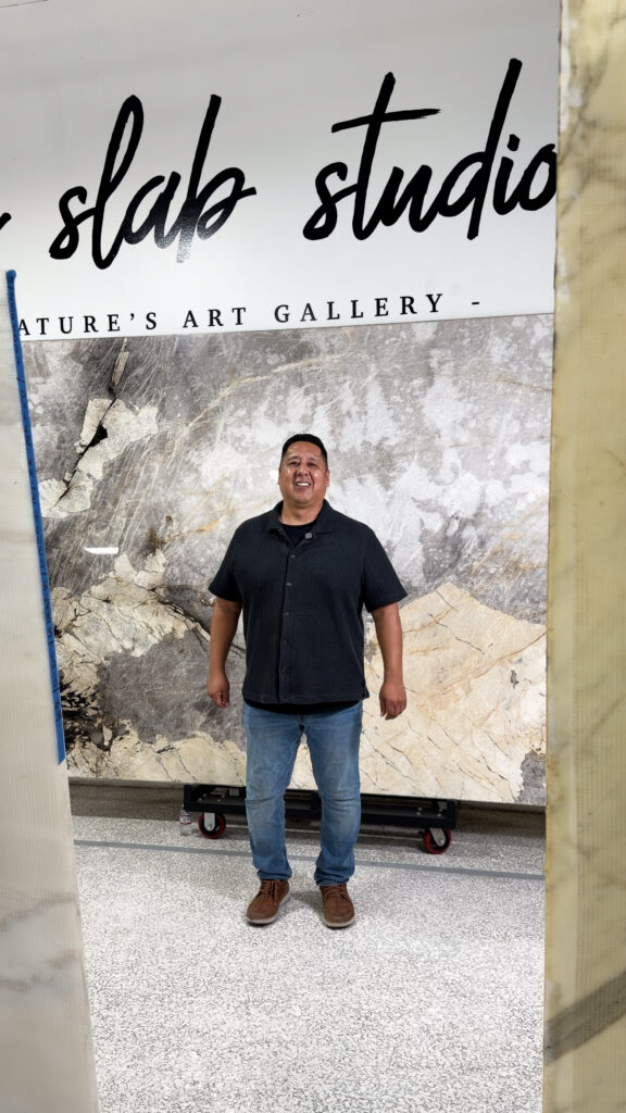 The Slab Studio Showroom The Slab Studio showroom in Santa Ana, California, in front of a premium natural stone slab.